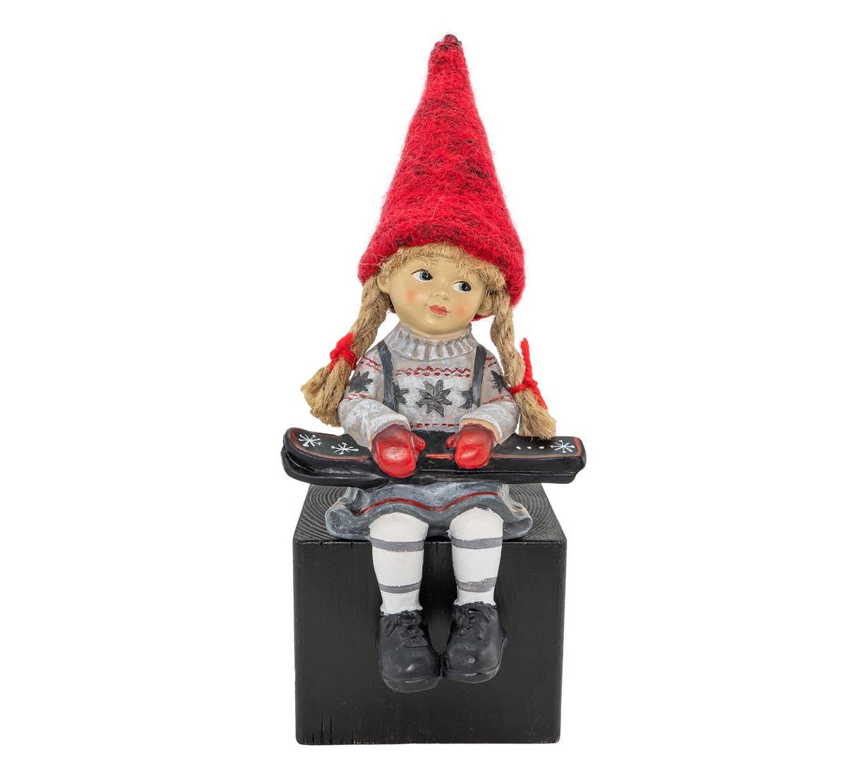 Girl sitting and holding skis, red hat